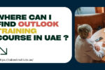 Promotional blog image asking 'Where can I find Outlook training course in UAE?' in bold, colorful text. The design includes a smiling woman working on a laptop on the left and a group discussion around a table on the right.