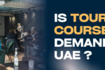 A classroom setting with students seated and a woman presenting a slideshow titled "What is a Role Profile?" on a projector screen. On the right, bold text reads: “IS TOURISM COURSE A DEMAND IN UAE?” with “TOURISM COURSE” highlighted in yellow. The Zabeel Institute logo and website link (https://zabeelinstitute.ae/) appear on the top and bottom right respectively.