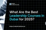 A banner with a dark green background and a subtle grid pattern, featuring the Zabeel International Institute of Management & Technology logo. The question on the left is: "How Do Business Training Classes Improve Team Performance?". The words "Business Training Classes" are highlighted in a pale yellow. The website "https://zabeelinstitute.ae/" is at the bottom left. The right side features a smiling, confident woman in a plaid blazer with her arms crossed, standing in a modern training or seminar room with other professionals in the background. The image is cropped in an arch shape. The overall theme is corporate training and team improvement.