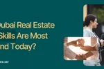 Banner for Zabeel Institute article asking 'Which Dubai Real Estate Market Skills Are Most in Demand Today?' with an image of real estate agents talking and a handshake over a house model.