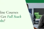 Smiling developer in glasses working on computers; addressing the question "Which Online Courses are Best to Get Full Stack Developer Jobs?"