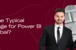 Smiling professional man pointing to a keyboard key with ".bi" (Business Intelligence); asking "What is The Typical Salary Range for Power BI Jobs in Dubai?"