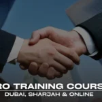 A professional banner with a dark blue overlay and a blurred background of modern buildings and skyscrapers. The main focus of the image is a close-up shot of two people in business suits shaking hands, symbolizing a deal, partnership, or successful business outcome. The text "PRO TRAINING COURSE" is displayed in large, bold, white letters at the bottom, with "DUBAI, SHARJAH & ONLINE" written in smaller text below it. The overall image conveys a sense of business professionalism and success.