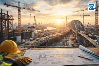 An engineering workspace with a yellow hard hat, safety gloves, and technical blueprints overlooking a large-scale construction site at sunset, promoting the Certified Cost Technician course at Zabeel Institute.